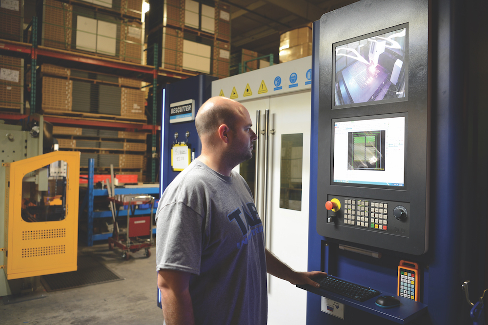 Andy Brizek using Laser Cutter at TAB Industries